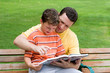 Photo: father and son reading father and son reading