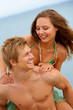 a young couple having fun on the beach