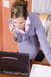 young woman in business suit working from home young woman in business suit working from home