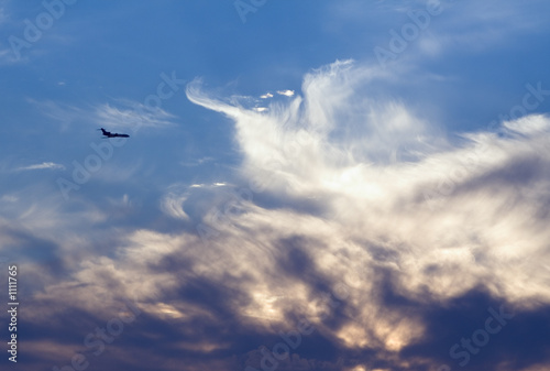 Photo: air-liner in evening cloudy sky air-liner in evening cloudy sky