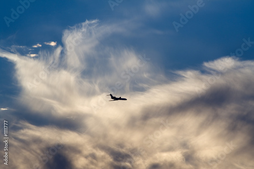 Photo: air-liner in evening cloudy sky air-liner in evening cloudy sky