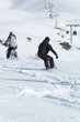 snowborder and biker downhill