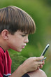 boy playing on cell phone