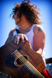 Photo: long haired man with guitar long haired man with guitar