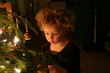 child at christmas tree