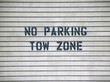 no parking tow zone sign