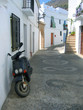 parked scooter in village street parked scooter in village street