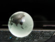 world globe atop laptop keyboard
