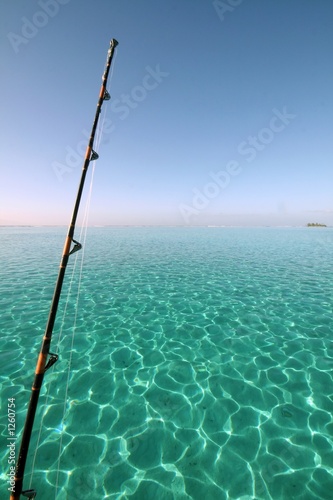 fishing rod over blue lagoon fishing rod over blue lagoon