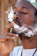 rastafarian man smoking marijuana