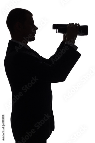 silhouette of man with binoculars