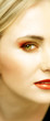 face of young blond woman with green eyes