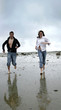 couple running on beach couple running on beach