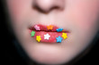 candy flowers on lips, blured face.