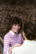 young woman talking to man at park