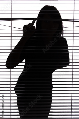 silhouette of woman looking through the blind silhouette of woman looking through the blind