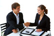 two businesspeople shaking hands.