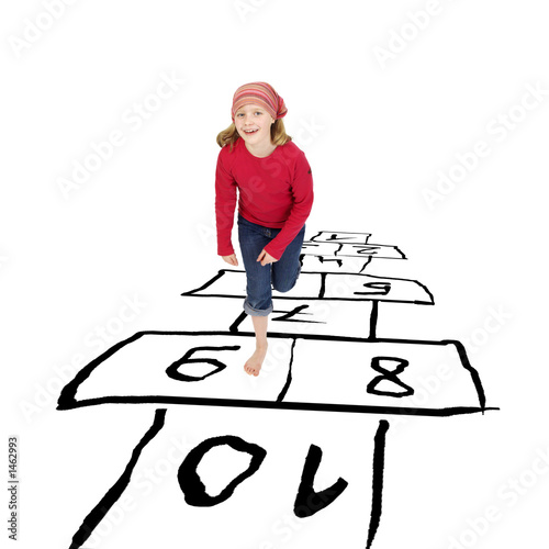 girl hopping around playing hopscotch