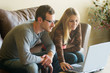 Photo: young couple looking at laptop young couple looking at laptop