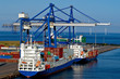 Container ship and loading crane in port