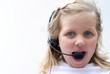 Foto: young girl talking with telephone headset young girl talking with telephone headset