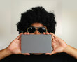 afro man holding blank card afro man holding blank card