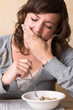 stiffling a yawn