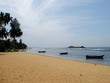 sandy beach with fishing boats
