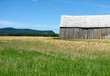 mountains and old wooden barn in the field