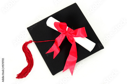 Photo: diploma resting on graduation cap diploma resting on graduation cap