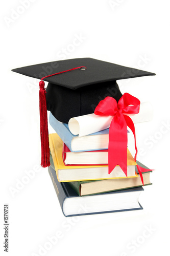 cap and diploma on stack of books cap and diploma on stack of books