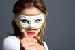 brunette with mask pointing