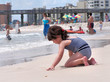 child playing in the sand