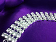 close up of dimond necklace on a violet background