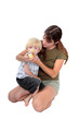 young mother giving respiratory medicine to her son