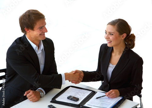 Photo: two businesspeople shaking hands. two businesspeople shaking hands.