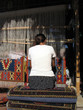 women weaving a carpet women weaving a carpet