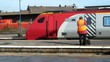 man in railway/train station standing beside train