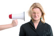 Foto: businesswoman with megaphone held to her head businesswoman with megaphone held to her head