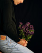 man waiting with flowers