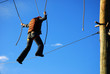 courageous woman standing on a steel wire