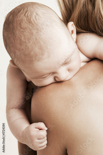 baby asleep on mother's shoulder