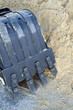 black shovel bucket near to a heap of sand