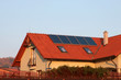 house with solar panels on the roof for water heating