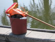 orange broom, bucket, water
