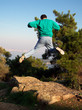 jumping man on a rock