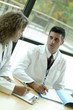 Photo: 2 doctors at table 2 doctors at table