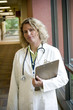 Photo: female medical professional with clipboard in hall female medical professional with clipboard in hall