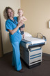 Photo: female medical professional standing with child female medical professional standing with child