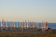 beach chairs and closed beach umbrellas. beach chairs and closed beach umbrellas.